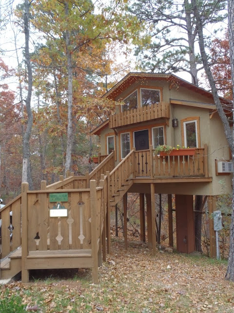 view of brown luxury treehouse cabin in Eureka Springs