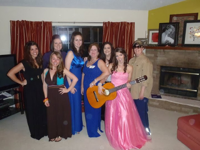 group of women posing in costumes at a Mardi Gras murder mystery party