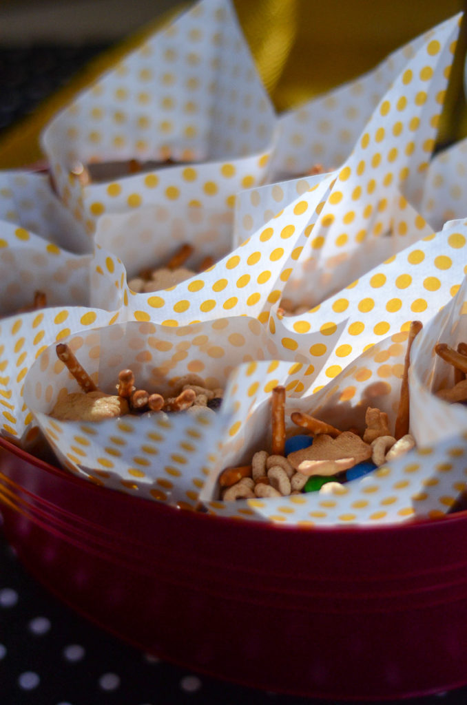 snack mix with Cheerios and pretzels inside yellow polka dot wrappers