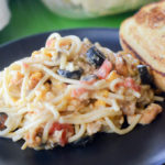 Cheesy Chicken Spaghetti on black plate - The Gifted Gabber