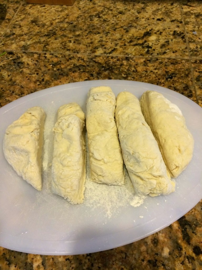 dough sliced up for frying on cutting board 