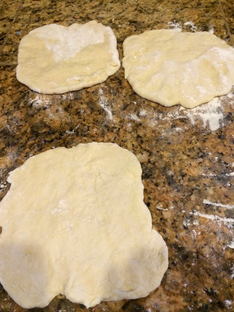 disks of dough on counter with flour 