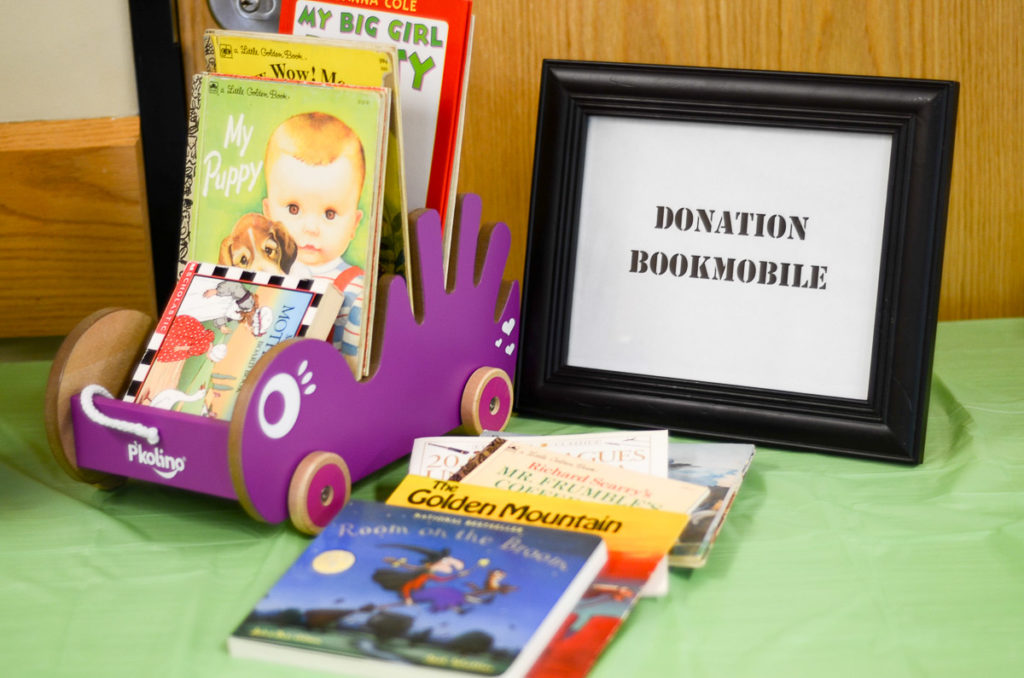 books, toy bookmobile and book donation sign at library birthday party