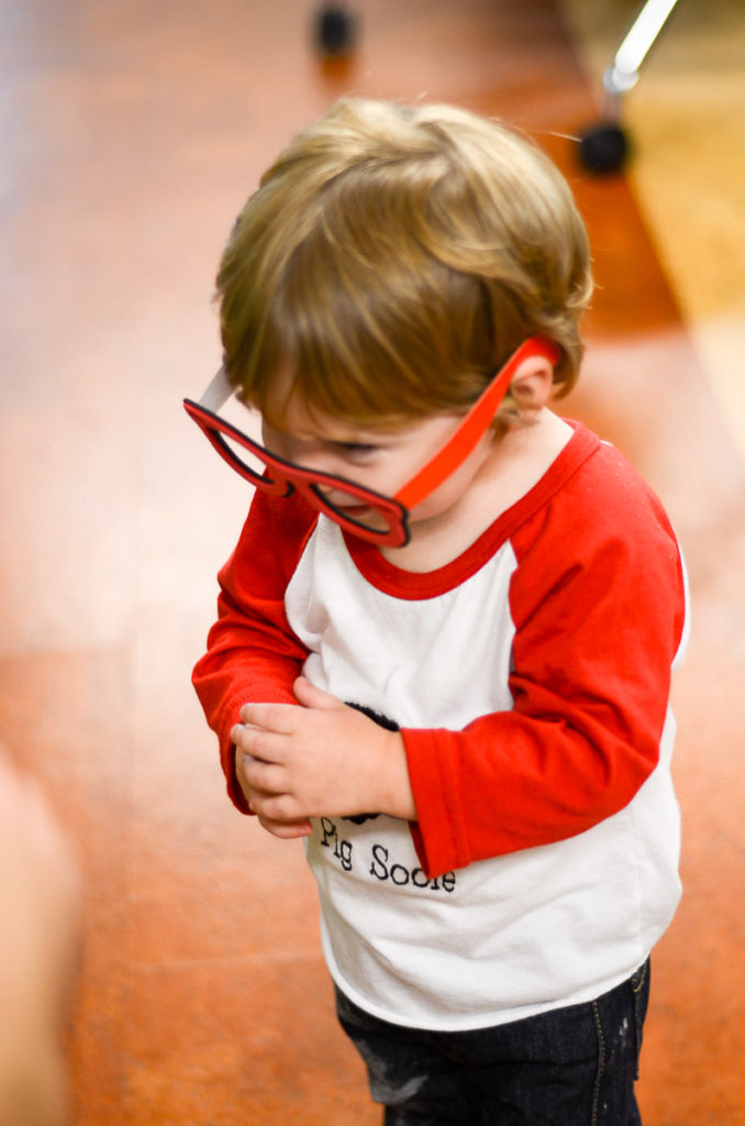 little boy with toy reading glasses