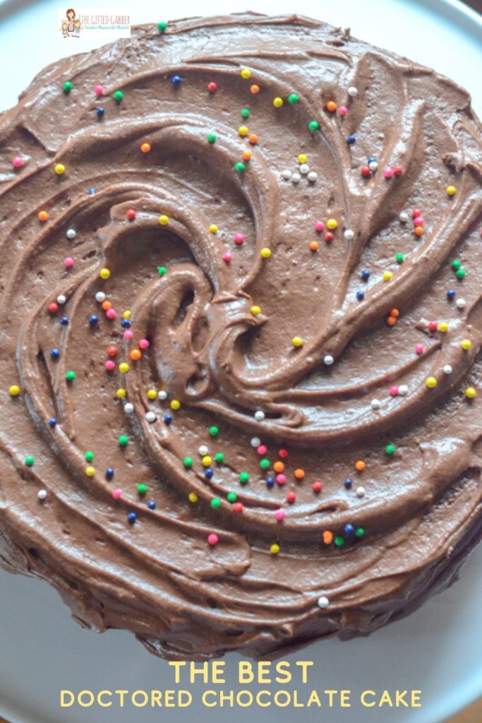 overhead image of semi-homemade chocolate cake with sprinkles on top of chocolate buttercream frosting 