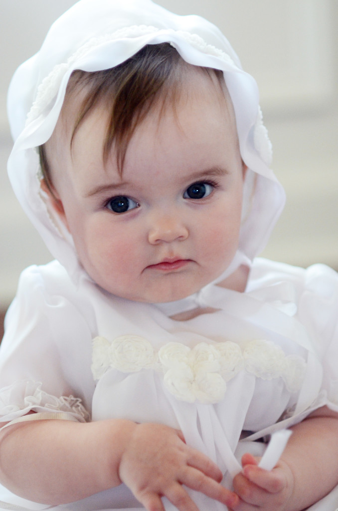 baby wears a custom christening gown from a wedding gown