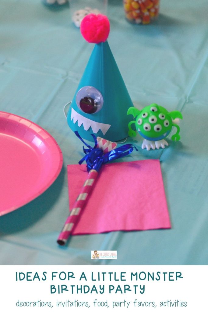 pink and blue party place setting at monster themed party with monster party favors and monster party hat