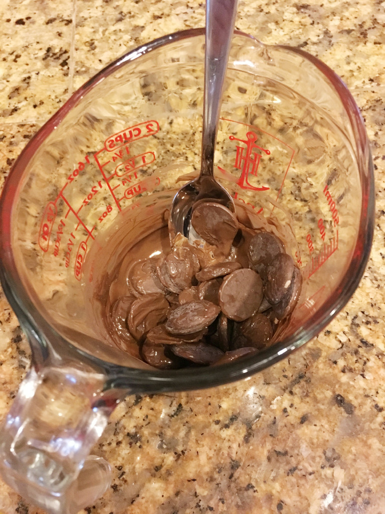 melted dark chocolate in glass measuring cup 