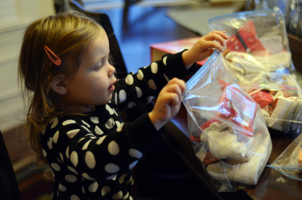 little girl makes hygiene kits for homeless as part of a blessing bags ministry