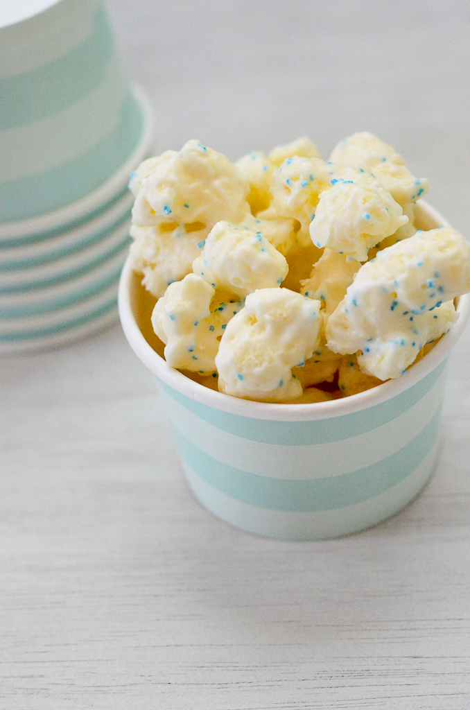 white chocolate puffed popcorn in a blue striped cup
