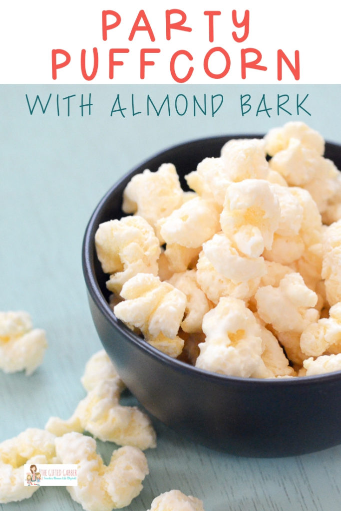 almond bark puffcorn in a black bowl on blue table 