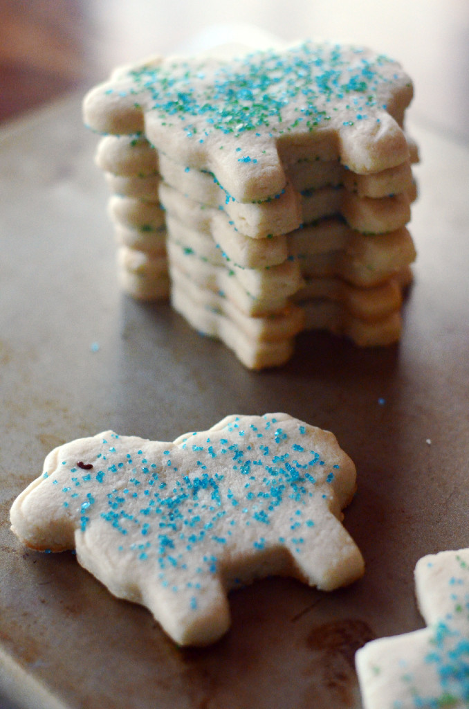 Easter lamb cookies stacked on cookie sheet