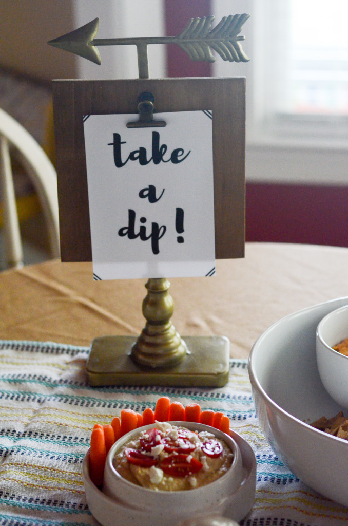 a take a dip sign at a dip party in front of dip appetizer with carrots