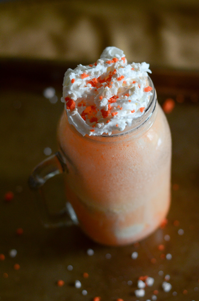 orange Fanta ice cream float with whipped cream and sprinkles