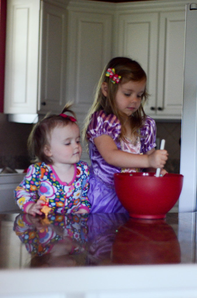 girls stirring in a red bowl 