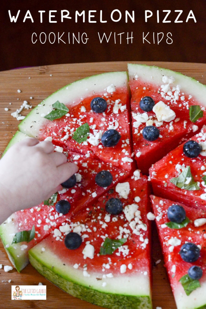 child helps garnish a watermelon pizza - with text overlay 