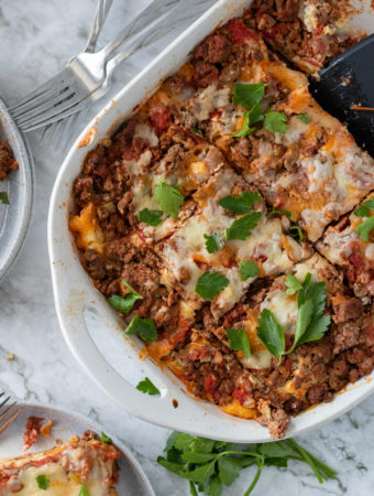 no boil lasagna with cottage cheese in white casserole dish on white background