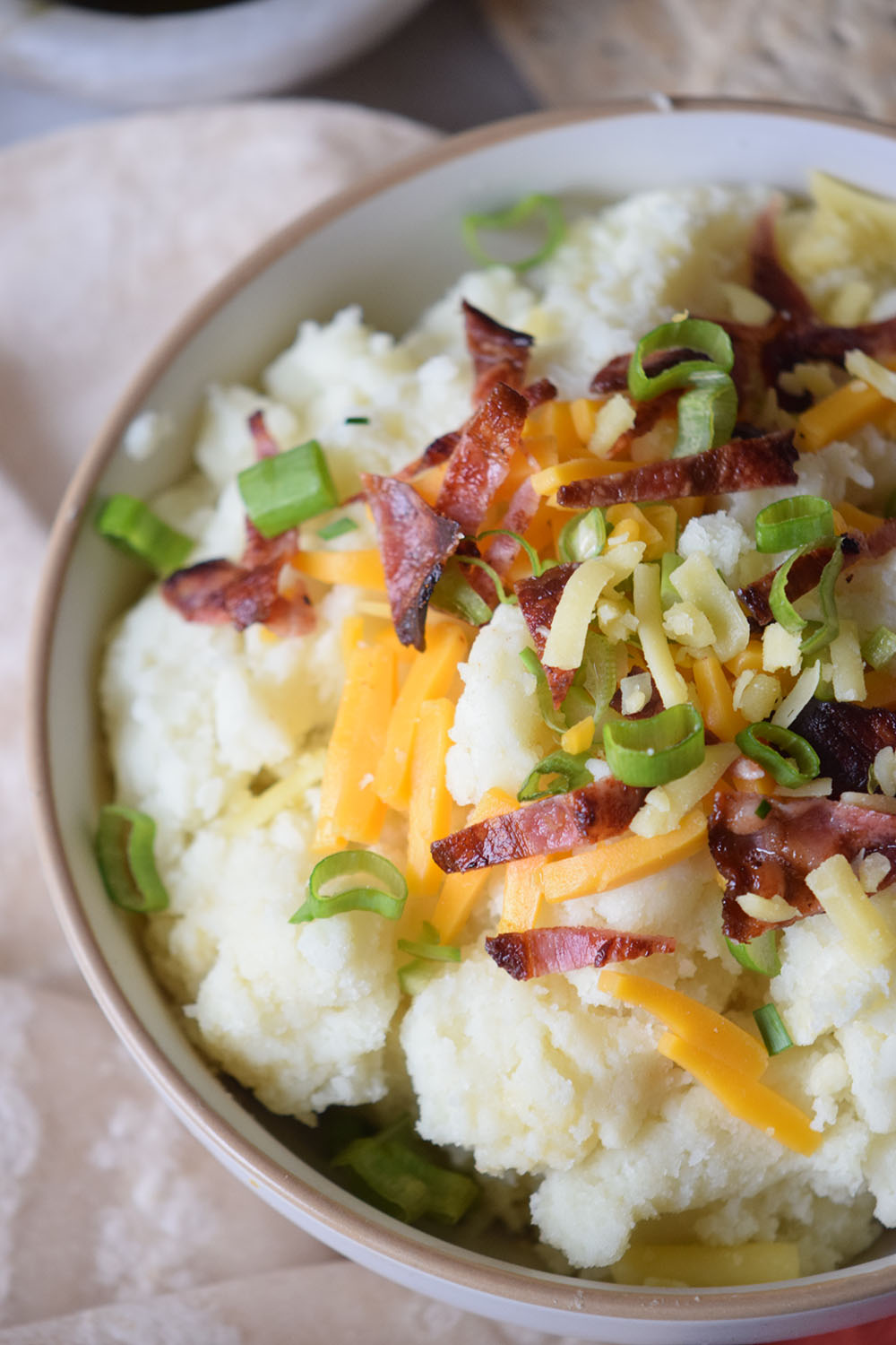 loaded baked potato dip in white bowl