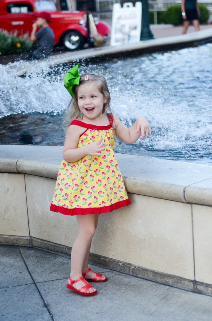 little girl laughs at Branson Landing water fountain