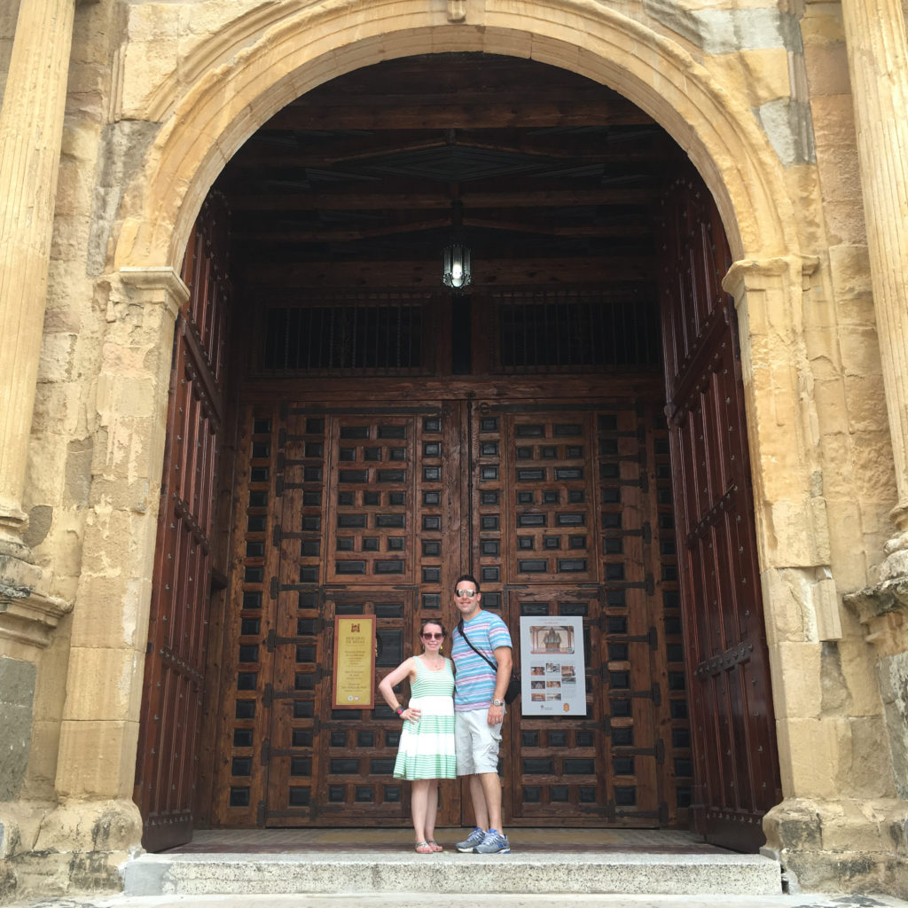couple stands in front of the doors of Iglesia San Jose in Panama