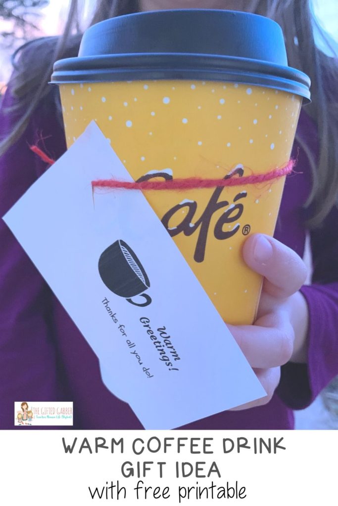 little girl holds warmest wishes thank you tag on coffee gift for teacher
