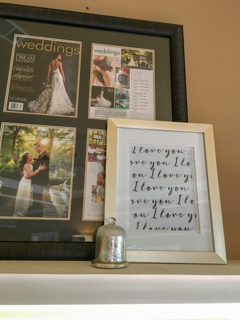 framed love note beside wedding pictures on mantle for Valentine's home tour
