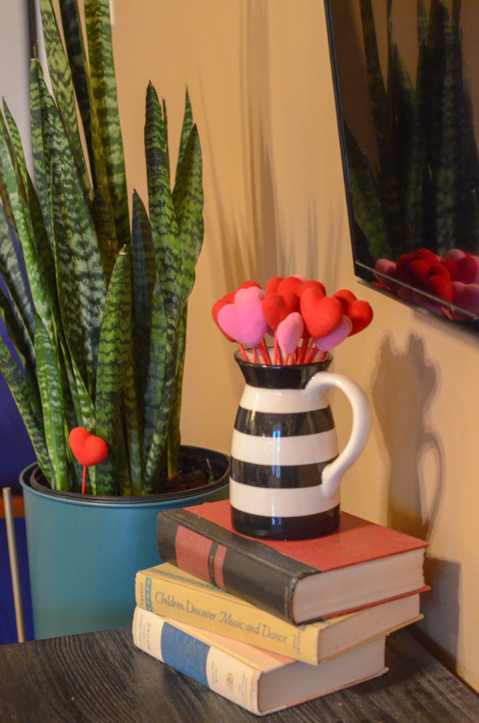 black and white vase with heart decoration and a Snake plant in a Valentine's home tour