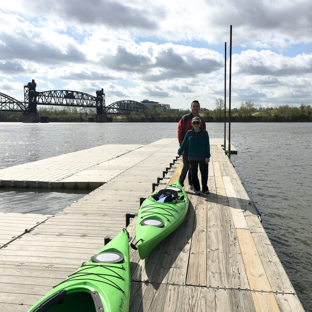 man and woman stand with kayaks on the Arkansas River 