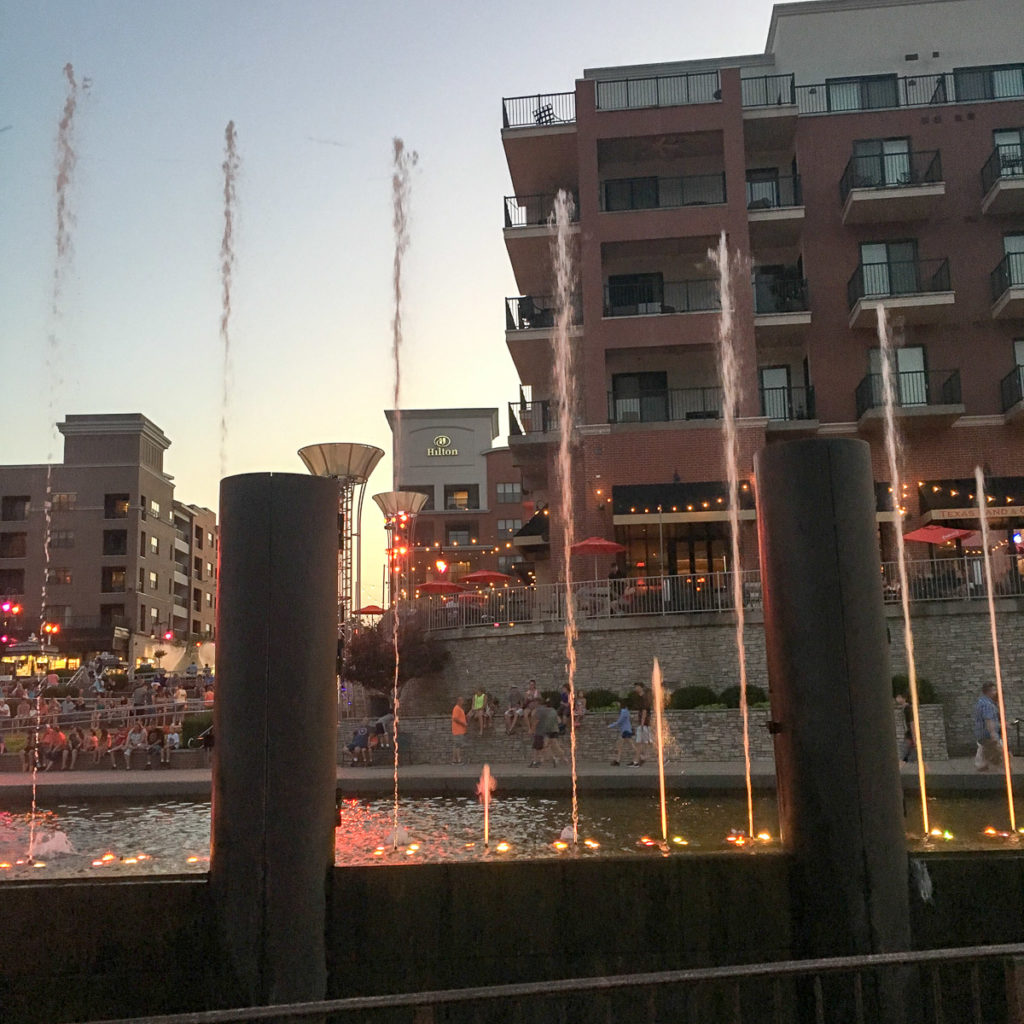 sunset view in Branson Landing with the Branson Landing light show in front