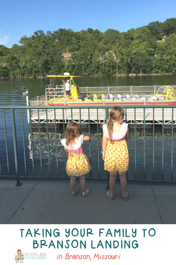 little girls staring at a large boat on the river behind Branson Landing