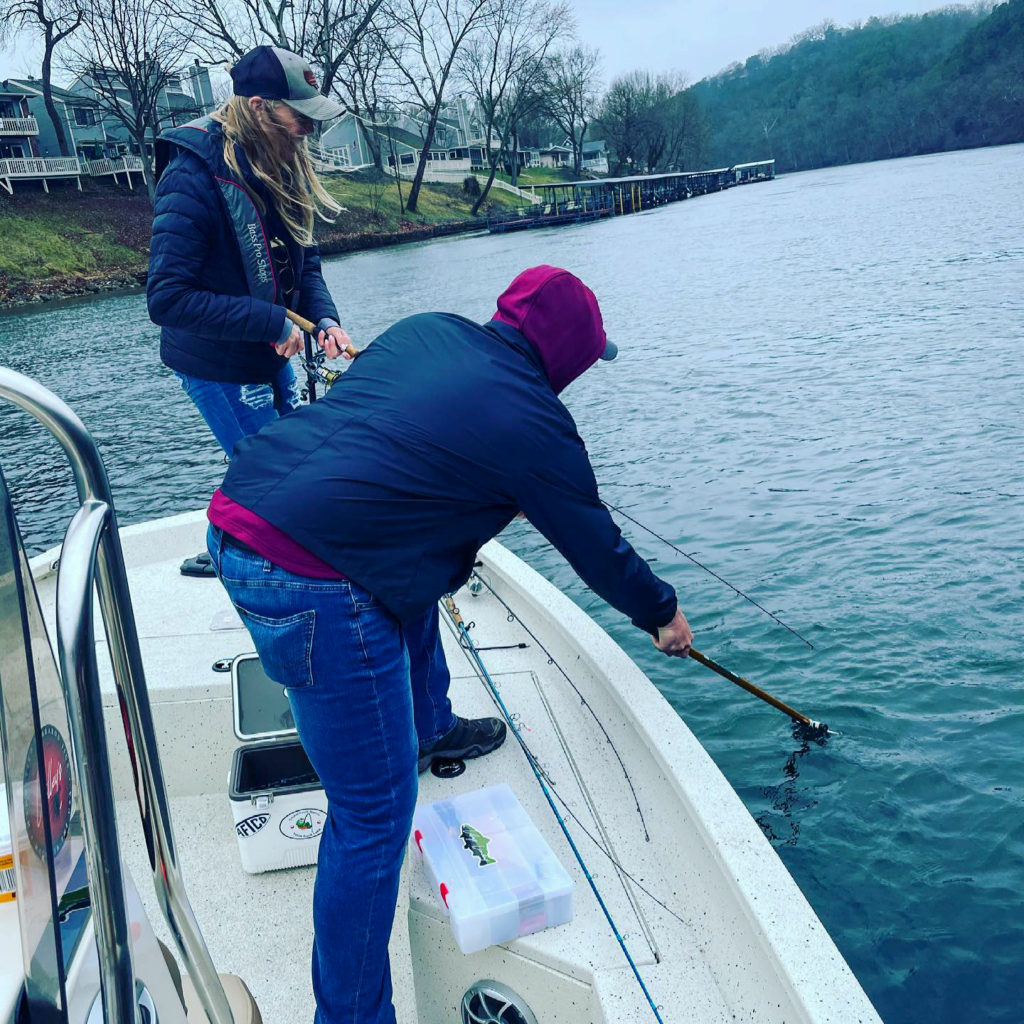 couple is trout fishing on Lake Taneycomo with OutCast Adventures fishing guide service