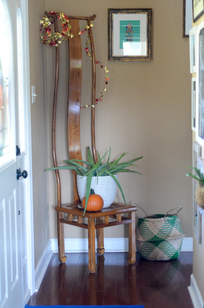 tall coat tree chair in entry decorated for fall 