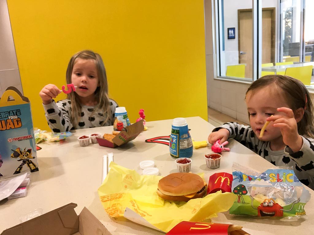 girls eat McDonald's happy meals at a McDonald's party for kids 