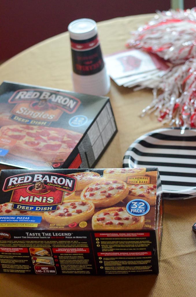 boxes of Red Baron mini pizzas on table with striped plates