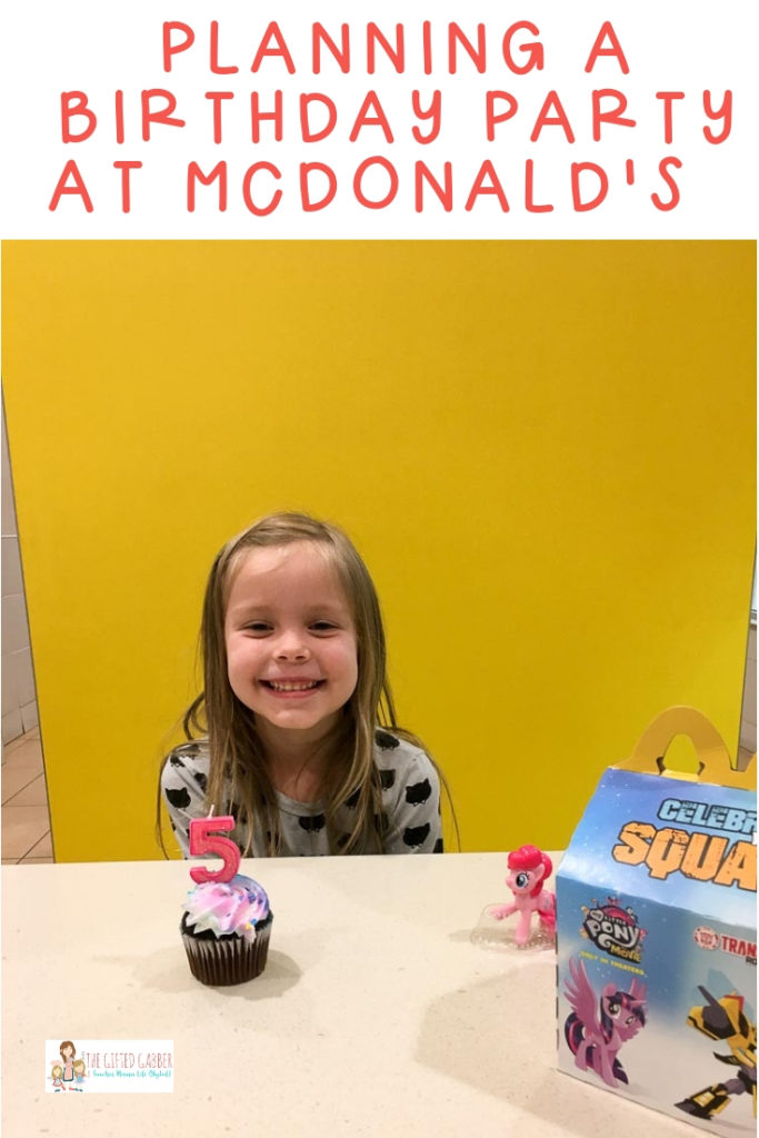 little girl with a birthday cupcake at her McDonald's birthday party with text overlay 