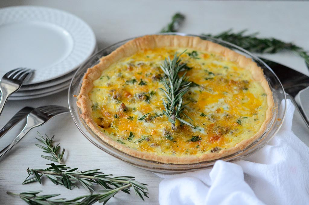 Cheddar and Sausage quiche on white table