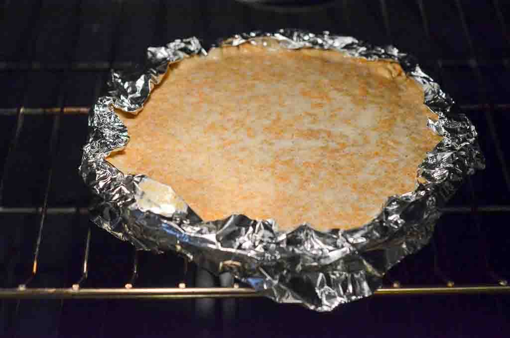pie in oven with foil