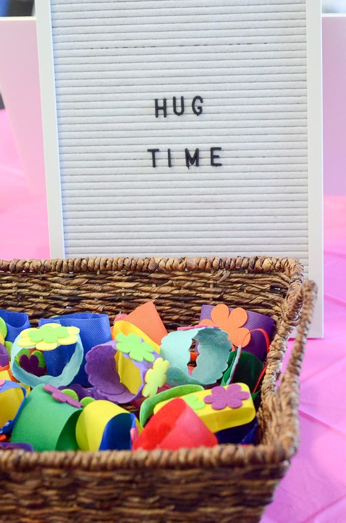 basket of Trolls Hug Time bracelets with letter board in background 