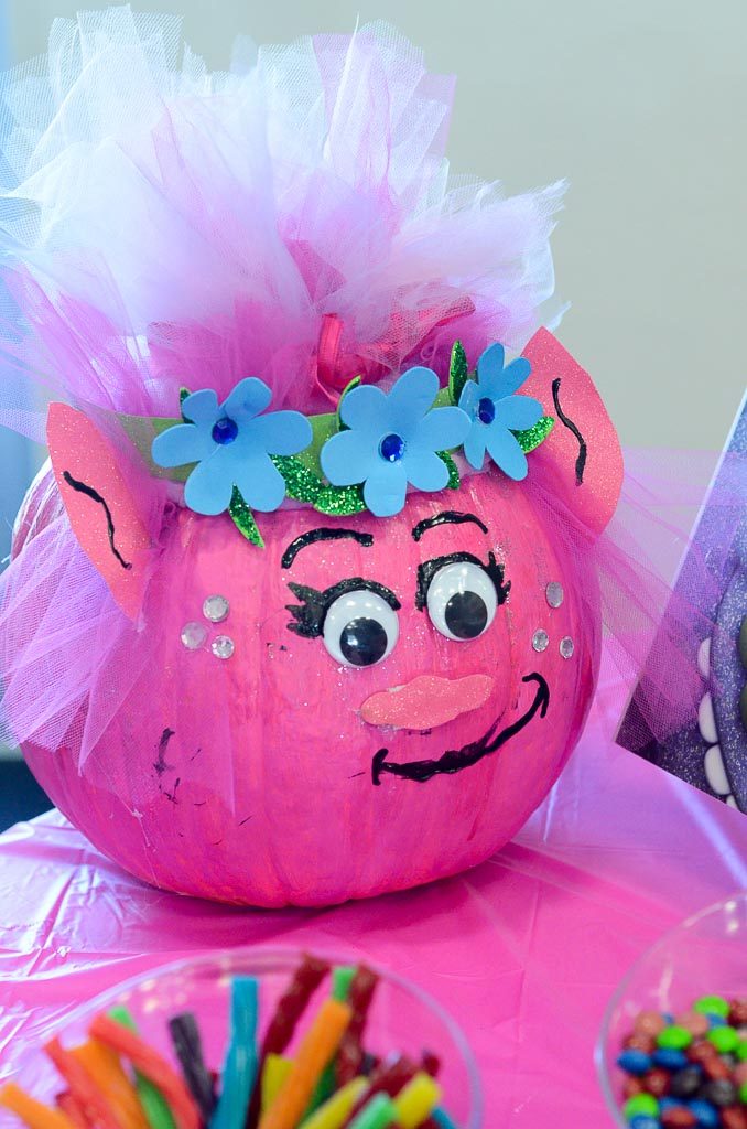 a Poppy pumpkin serves as party decor at a Trolls themed party