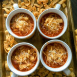 overhead view of stove top chili with tomato juice on a sheet pan