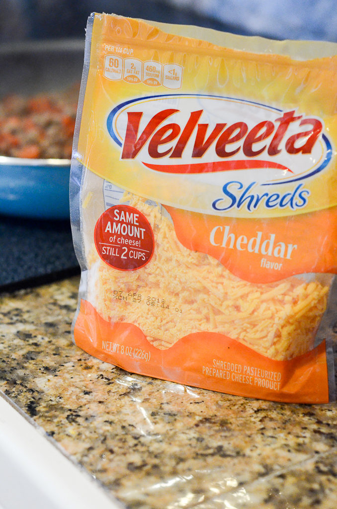 Velveeta Shreds package on counter in front of pan 