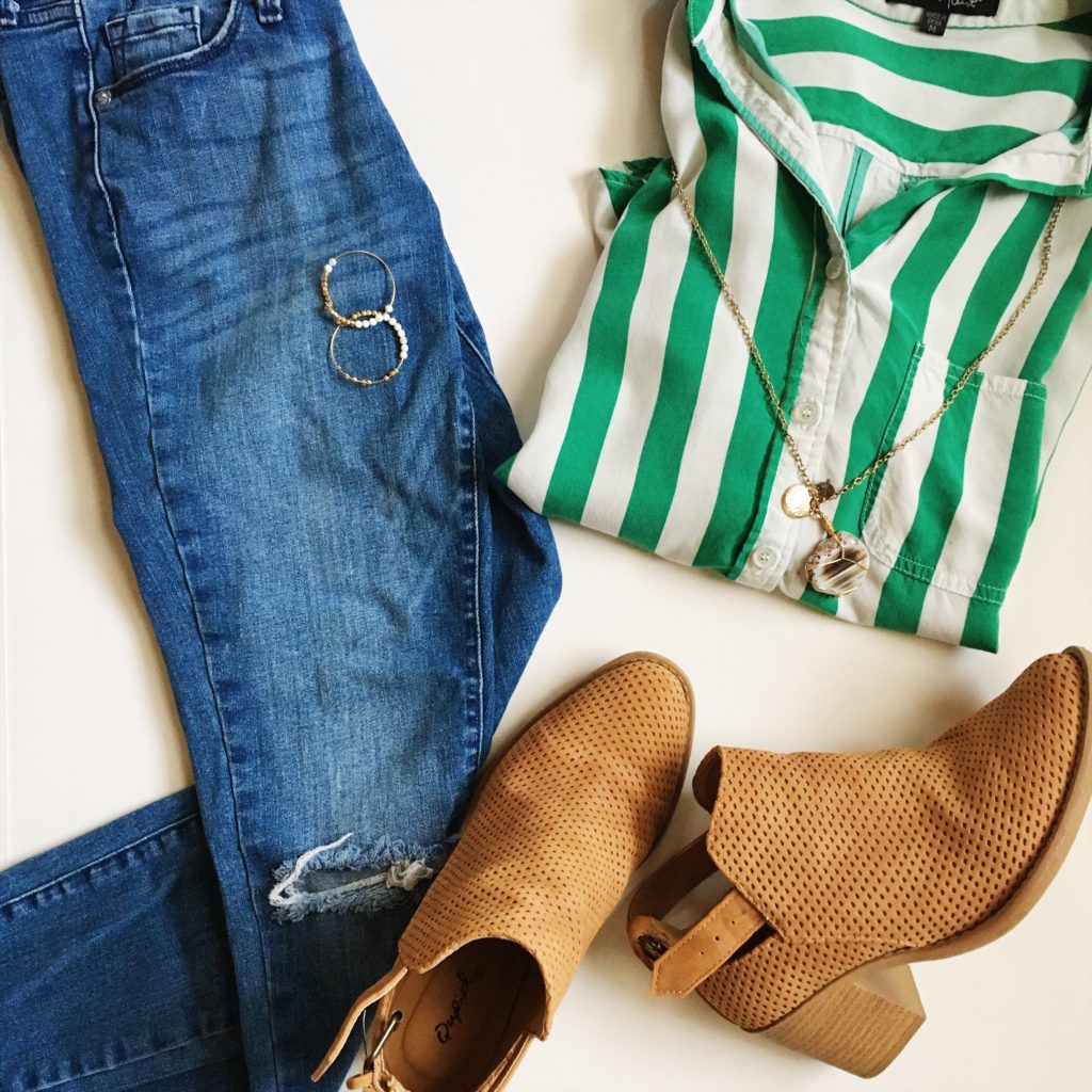 green striped blouse with jeans and tan booties in a flay lay image