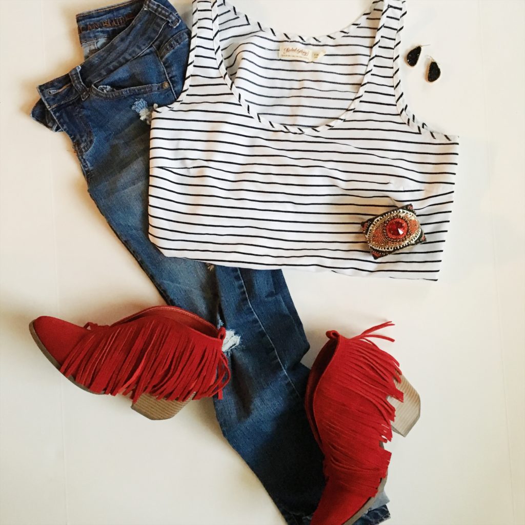 black and white striped tank with jeans and red fringe booties in a flay lay image 