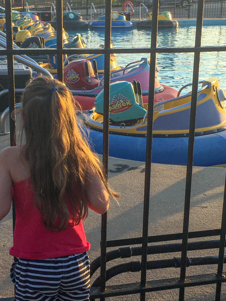 Branson Strip with Kids - Travel with Kids - The Gifted Gabber - Girl Watching Bumper Boats in Branson