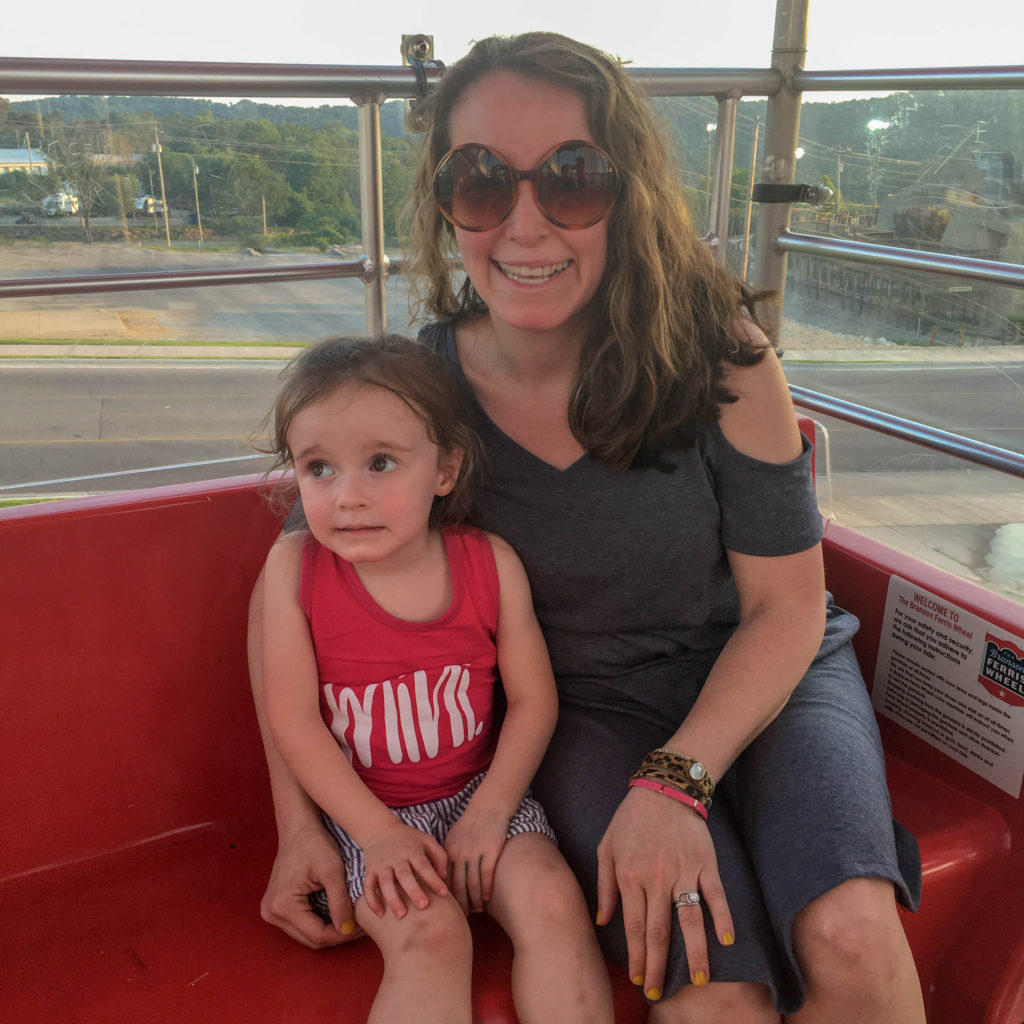 mother and little girl ride the Branson Strip ferris wheel 
