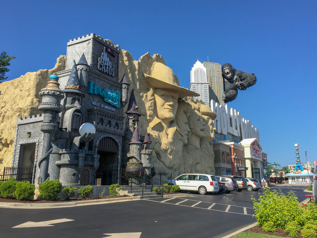 the Wax Museum with face carvings on the Branson Strip with cars in parking lot 