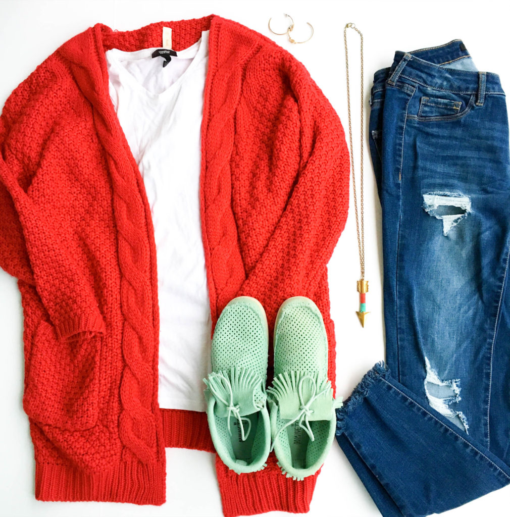 chunky red cardigan with teal booties and ripped jeans in flay lay image