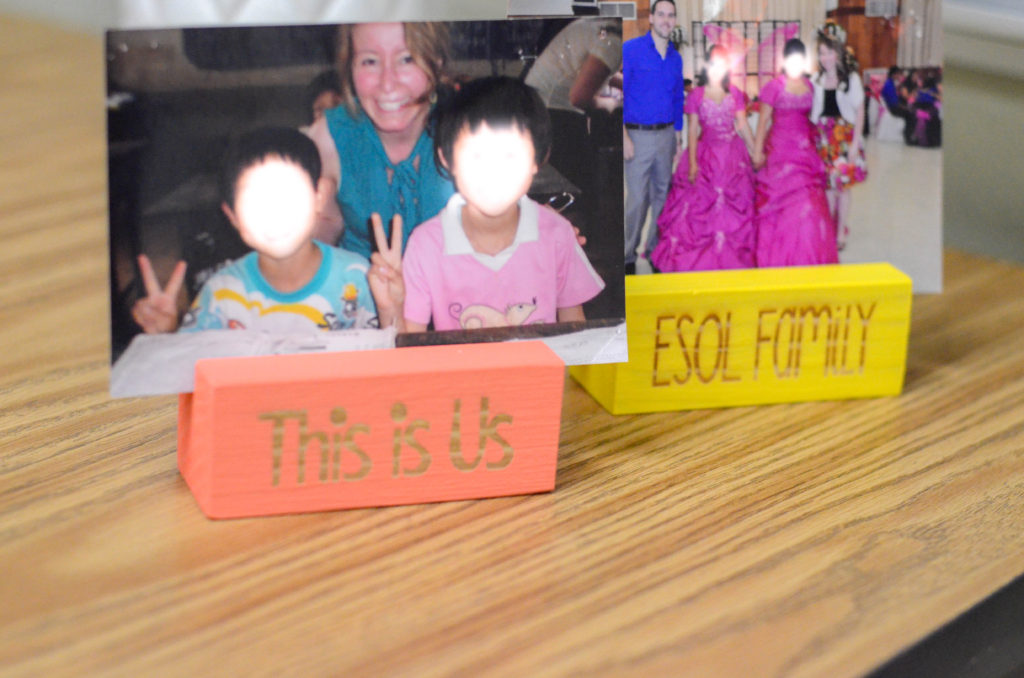 engraved photo holders on teacher desk with photos inserted