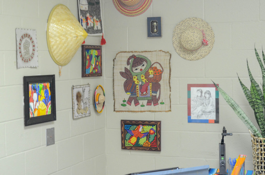 corner classroom art gallery with hats and art from around the world 