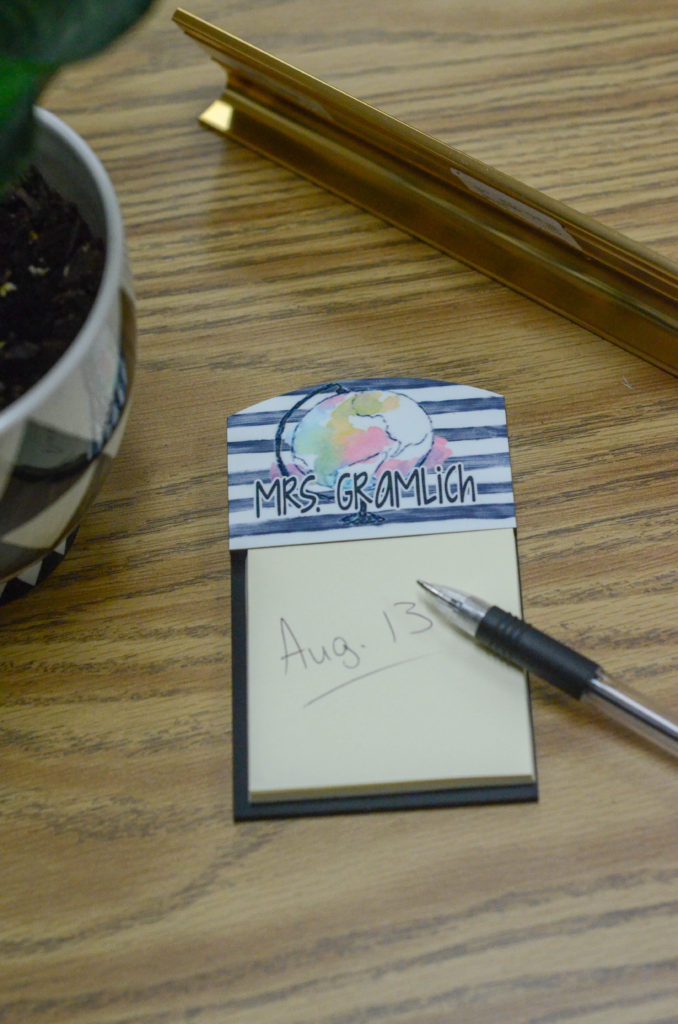 boho notepad holder with a globe and teacher's name holds a Post It note and pen